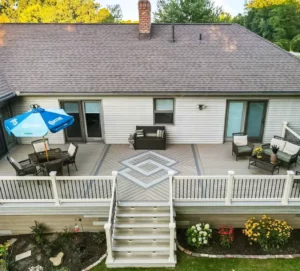 Photo of a composite deck with deck inlays, outdoor furniture, deck railing, deck steps, and in-step lighting - Deck Specialist in Ohio