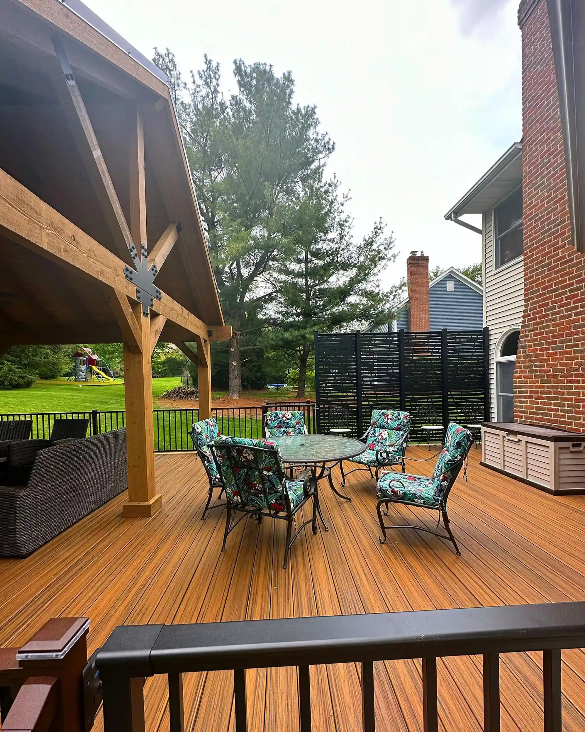 custom deck installer in northeast ohio Photo of a composite deck with custom pavilion, deck railing, and privacy screens.