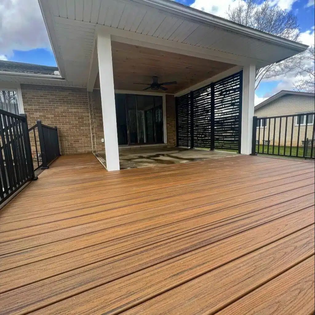 Grey composite deck with unique white and black geometric railing designs.