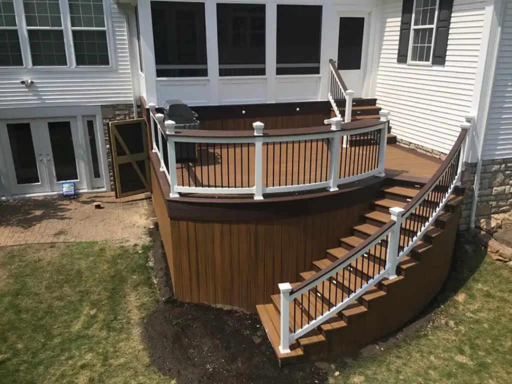 Photo of an elevated deck with stairs and deck railing.