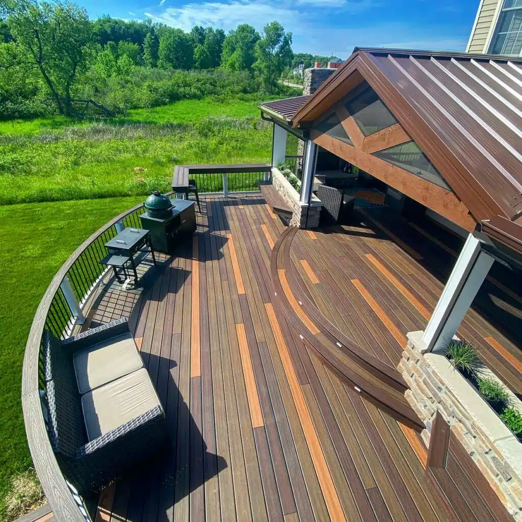 Photo of creative composite decking ideas, including curved deck, steps, and deck lighting.