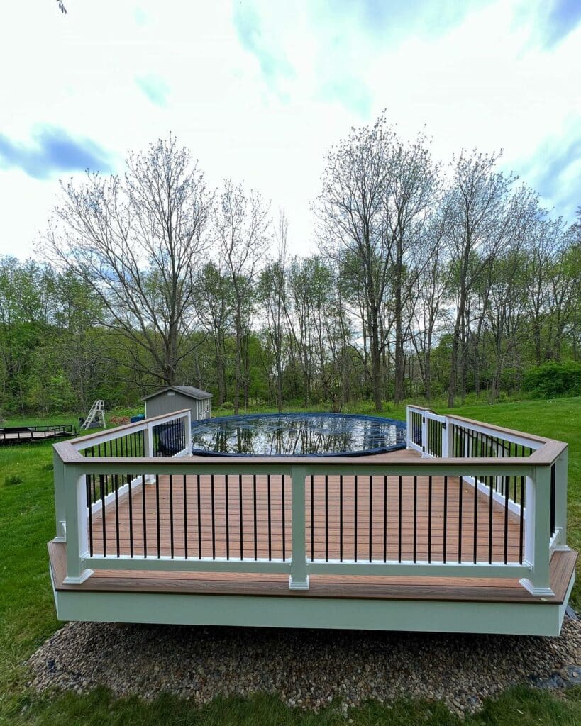 Photo of a pool deck with steps and gate made with composite decking
