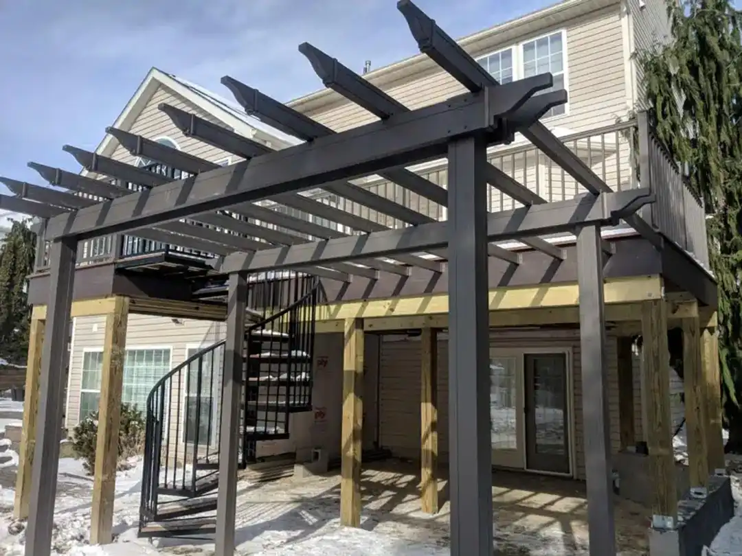 Photo of a traditional pergola attached to an elevated deck.