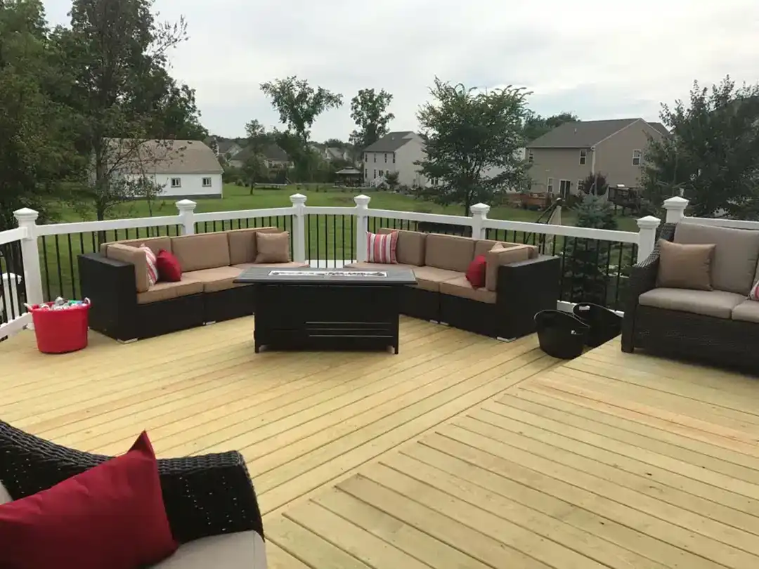 Photo of a wooden deck with outdoor furniture and deck railing.